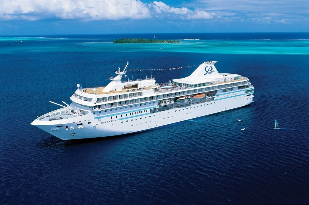 Paul Gauguin cruise ship cruising through tropical blue waters, ideal for luxury voyages in the South Pacific