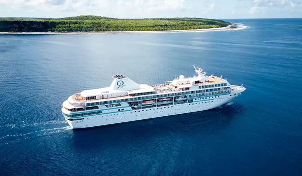 Ponant luxury yacht-style cruise ship sailing in pristine blue waters, offering an intimate French-inspired experience